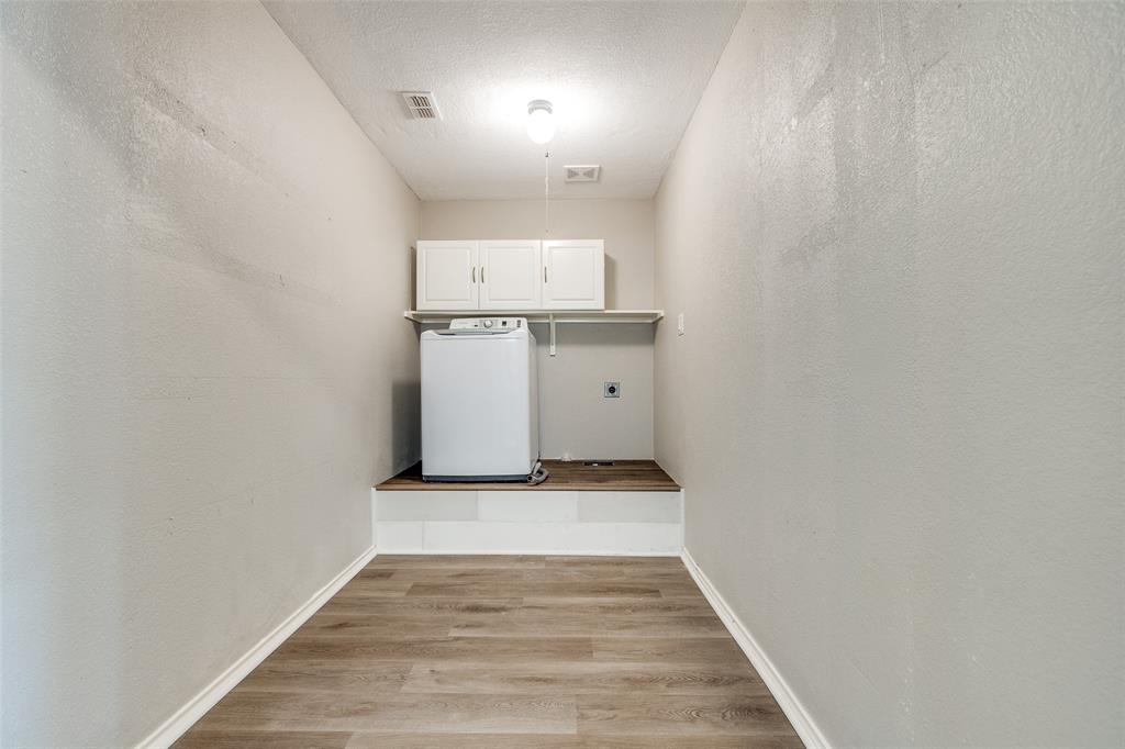 2624 Misty Harbor Drive Little Elm, TX 75068 - Photo 23 of 25 a view of storage and utility room with wooden floor