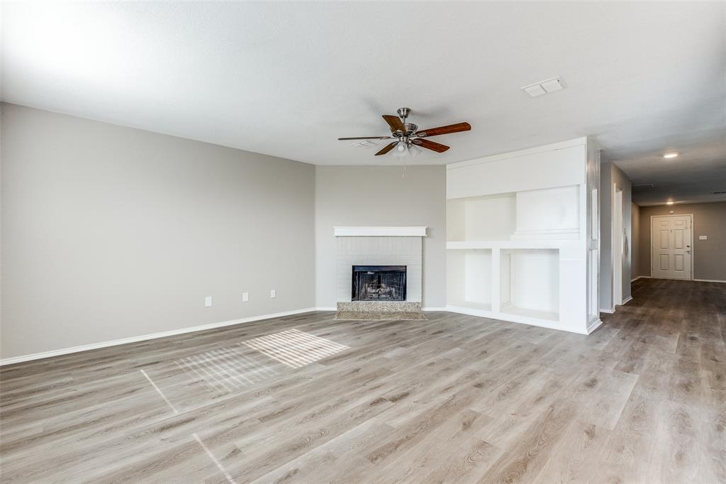 2624 Misty Harbor Drive Little Elm, TX 75068 - Photo 3 of 25 a view of an empty room with a fireplace and a window