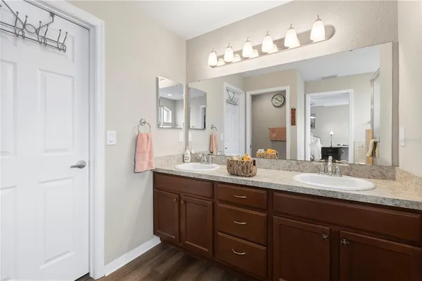 a bathroom with a double vanity sink and a mirror