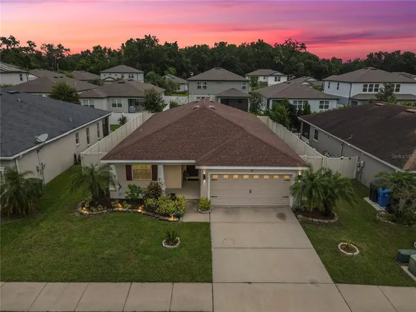 an aerial view of residential houses with outdoor space and swimming pool