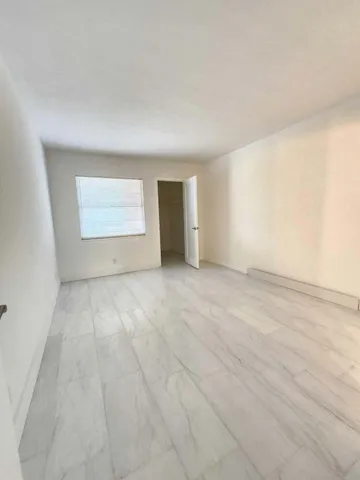 an empty room with a empty space and windows