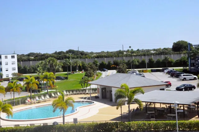 an aerial view of a house having swimming pool having patio