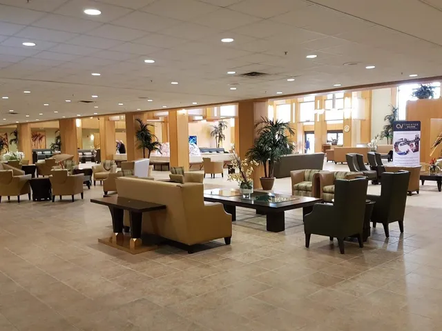 a living room with lots of furniture and a large window