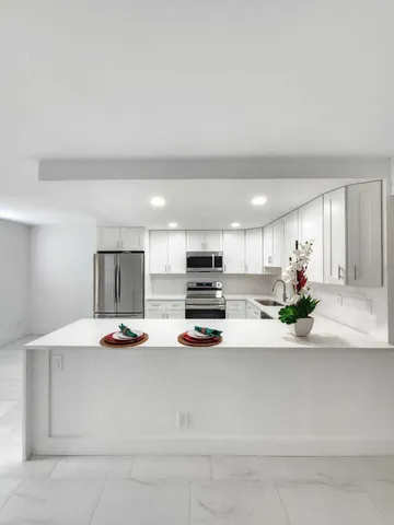 a kitchen view with microwave a stove and cabinets