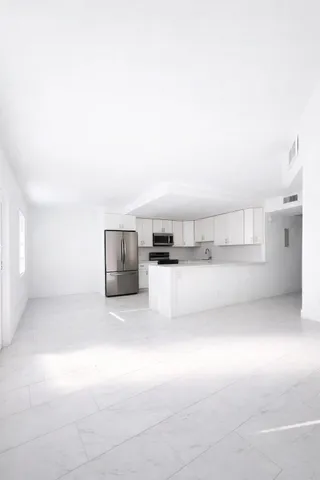 a view of kitchen and kitchen with furniture