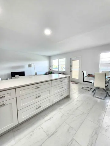 a spacious bathroom with a granite countertop sink and a mirror