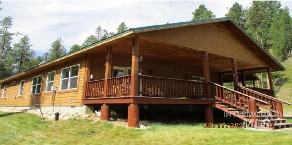 17567 Edwardsburg Road Yellow Pine, ID 83677 - Photo 1 of 11 Ranch-style residence featuring a prominent covered porch, wood siding, and white-framed windows