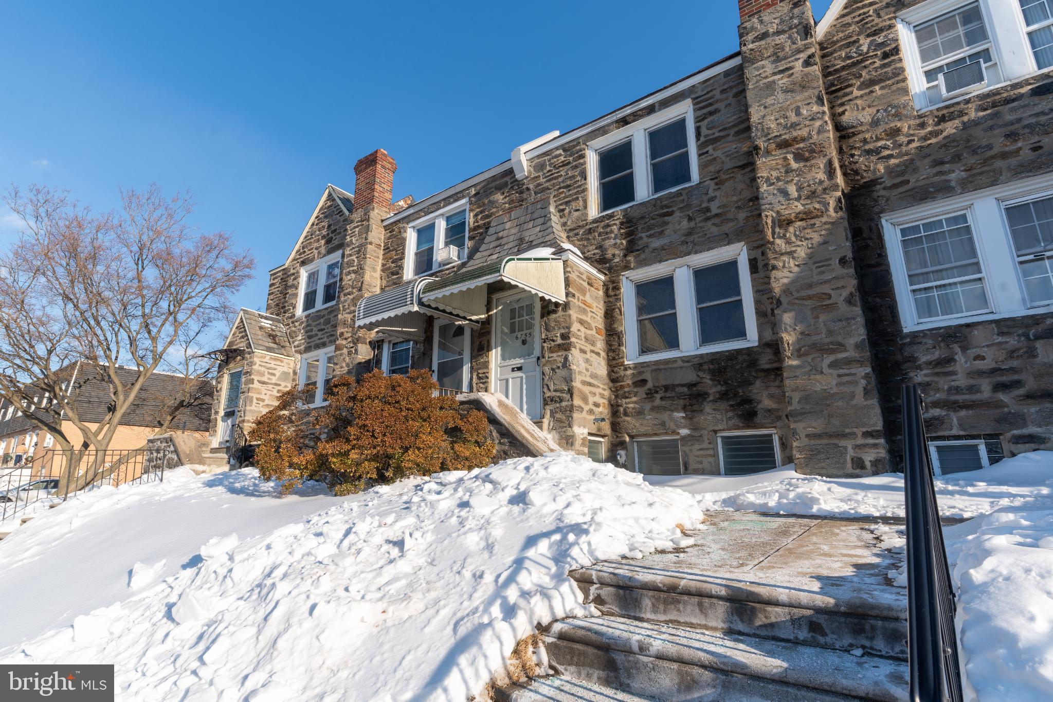 Charming stone facade in a winter wonderland.