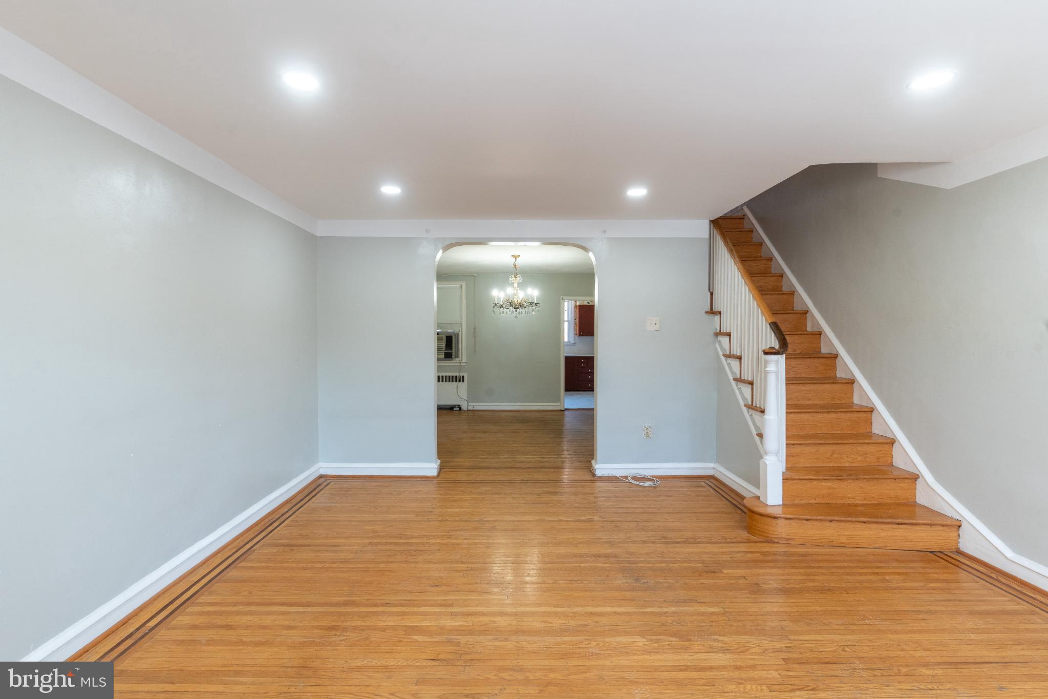 Spacious entryway with elegant staircase.