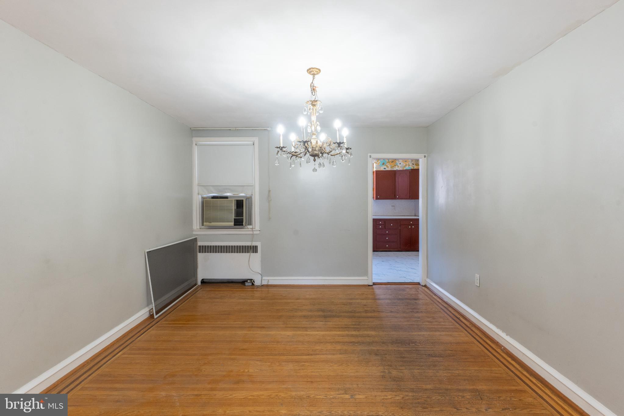 Spacious room with elegant chandelier charm.