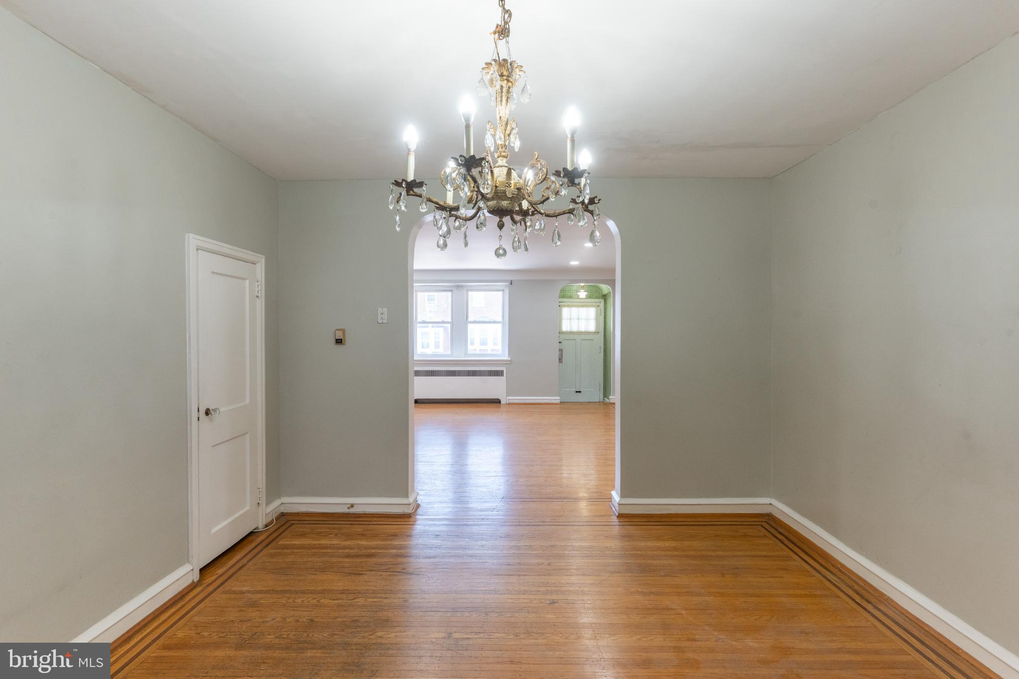 Spacious entryway with elegant chandelier.