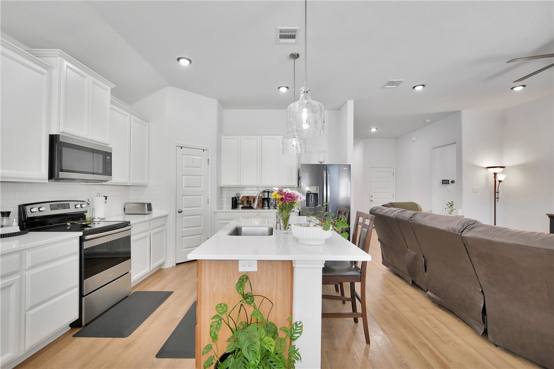 1908 Meridian Court Bryan, TX 77807 - Photo 12 of 46 Open kitchen with a large breakfast island and designer llighing