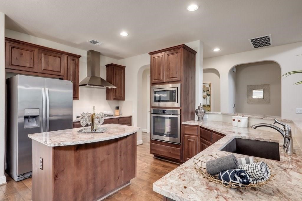 10825 Ballard Path Austin, TX 78717 - Photo 12 of 39 a kitchen with stainless steel appliances granite countertop a sink refrigerator and cabinets