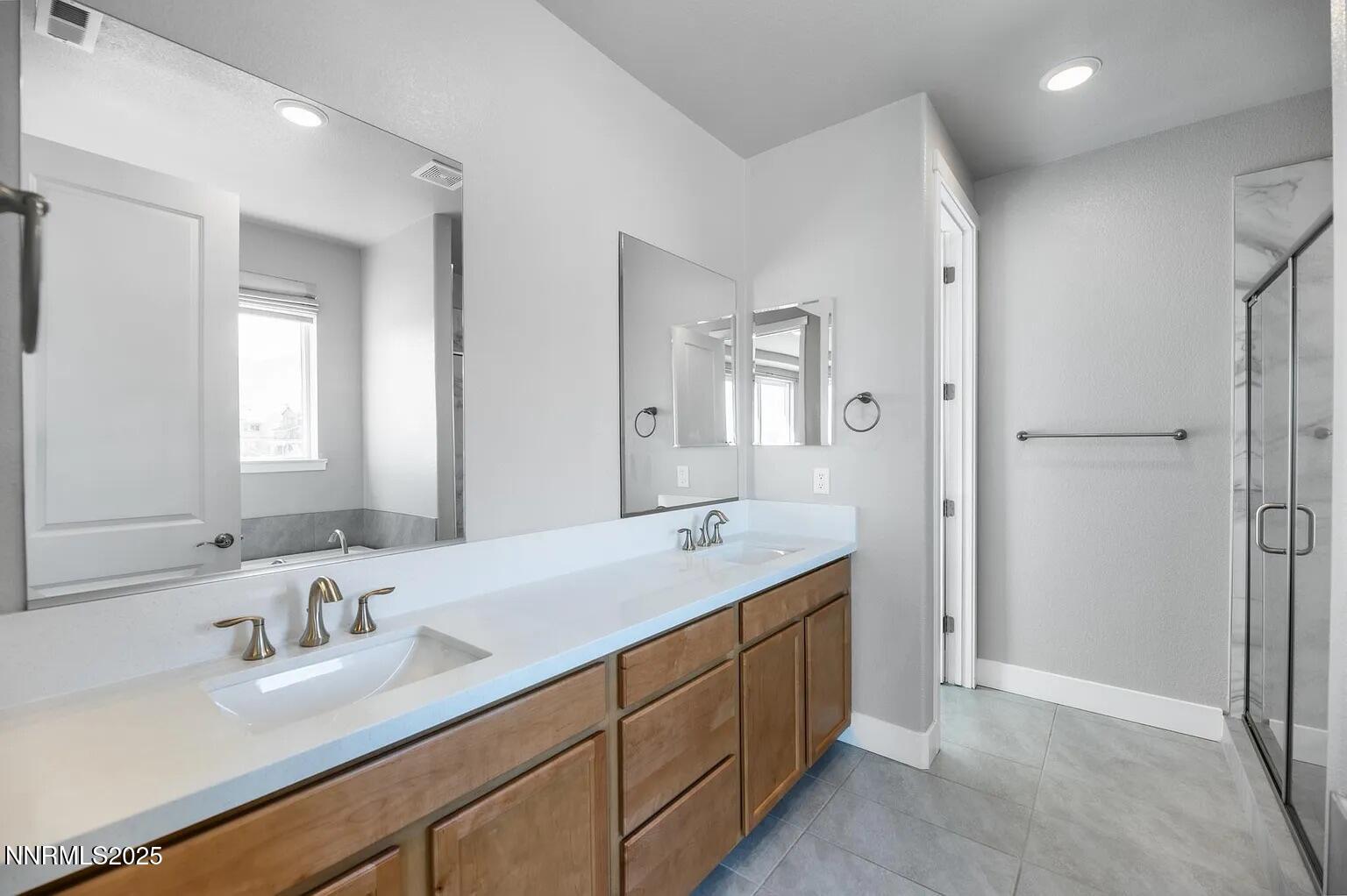 7731 Enclave Key Road Reno, NV 89506 - Photo 13 of 43 a bathroom with a granite countertop sink mirror and double