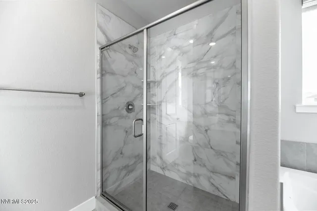 a bathroom with a glass shower door