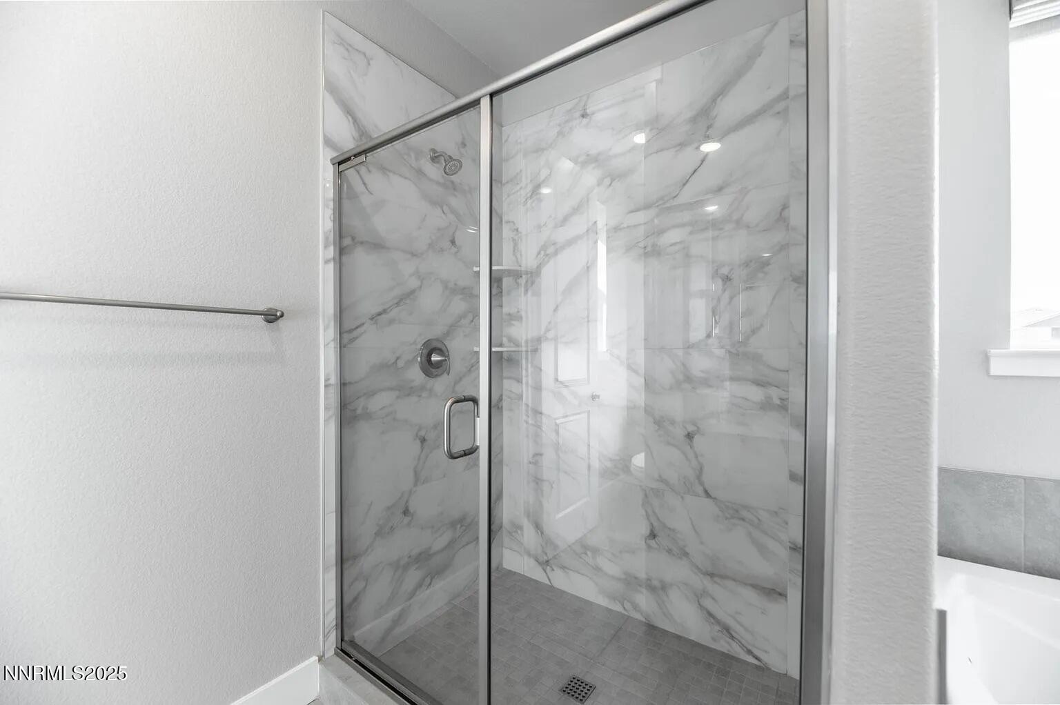 7731 Enclave Key Road Reno, NV 89506 - Photo 15 of 43 a bathroom with a glass shower door
