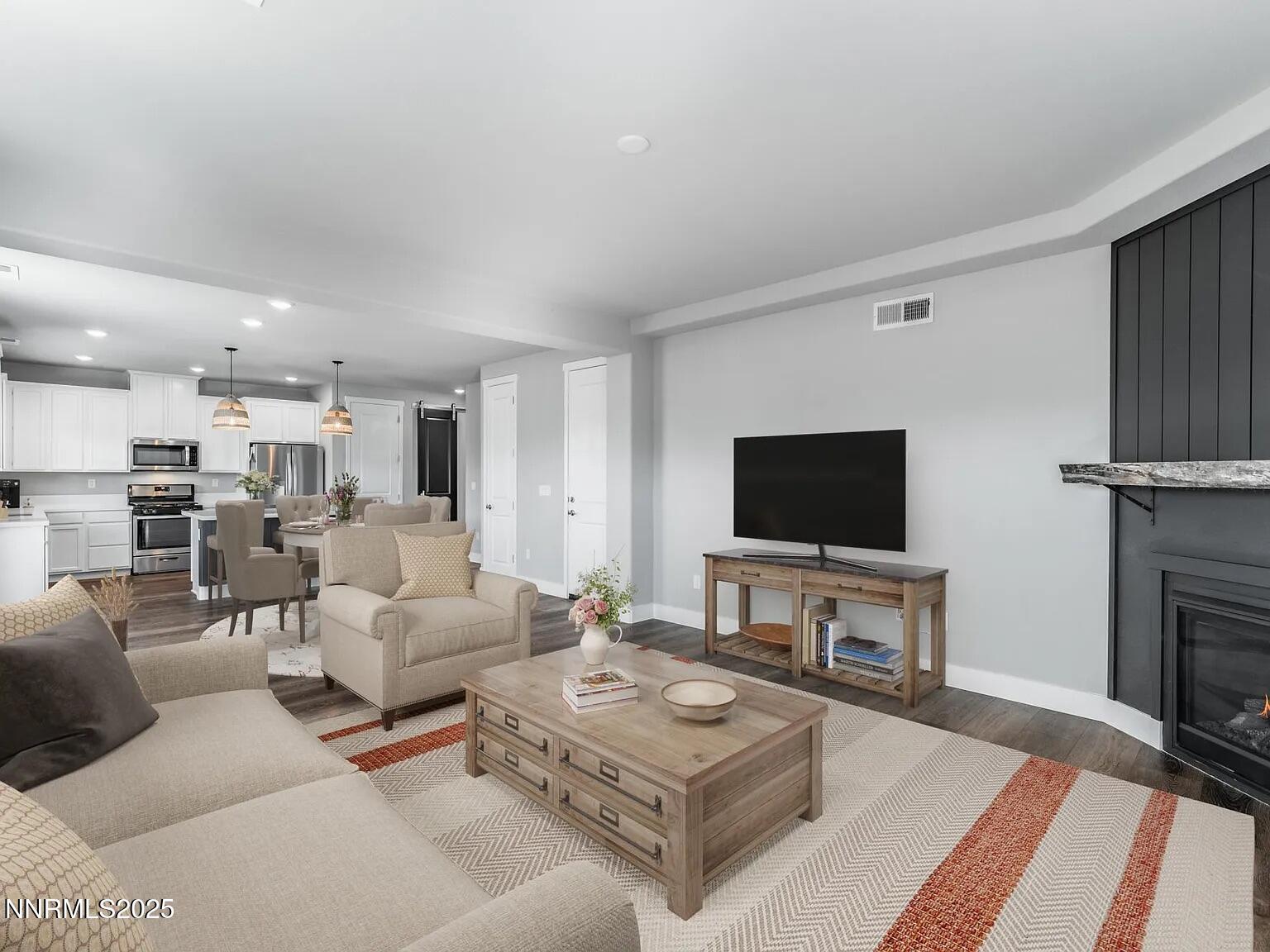 7731 Enclave Key Road Reno, NV 89506 - Photo 5 of 43 a living room with furniture a flat screen tv and kitchen view