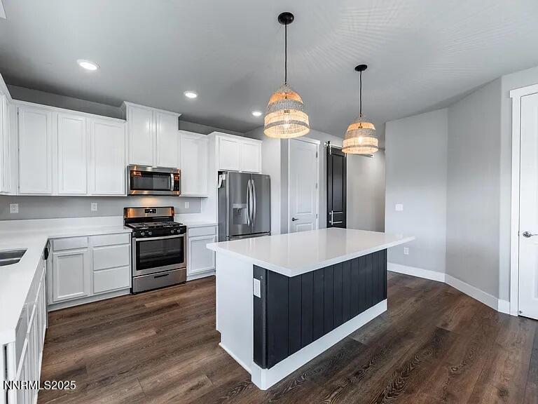 7731 Enclave Key Road Reno, NV 89506 - Photo 10 of 43 a kitchen with kitchen island a sink stainless steel appliances and cabinets