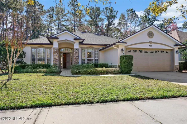 a front view of a house with a yard and garage