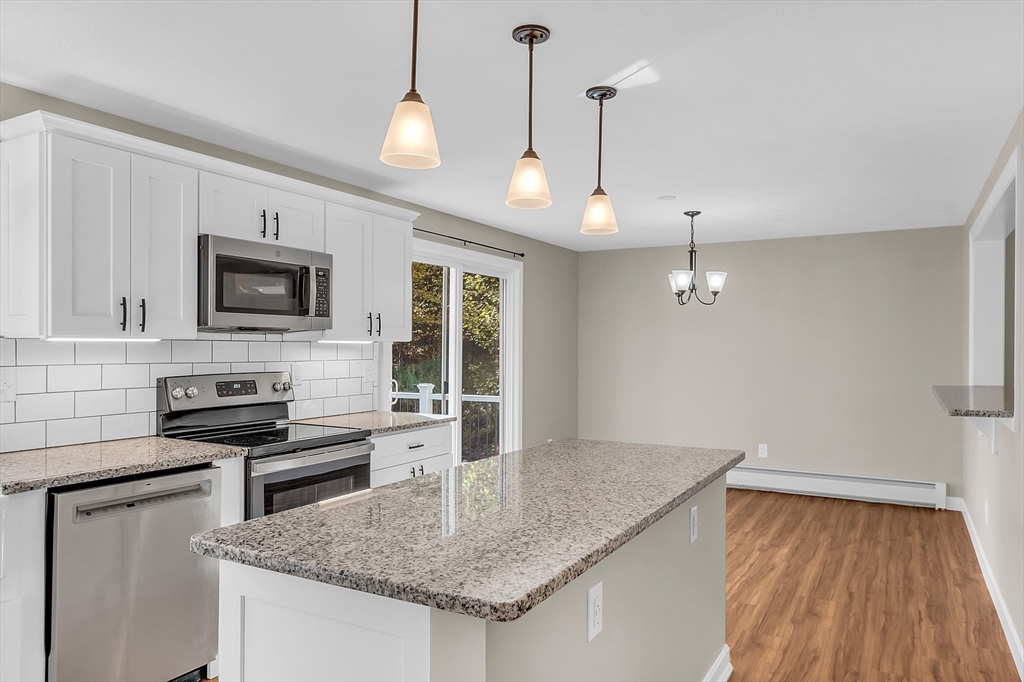 3 Reed Hill Road Wales, MA 01081 - Photo 19 of 23 a kitchen with granite countertop stainless steel appliances a stove sink and microwave