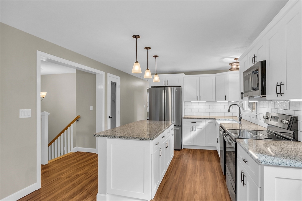 3 Reed Hill Road Wales, MA 01081 - Photo 21 of 23 a kitchen with stainless steel appliances granite countertop a sink stove and refrigerator