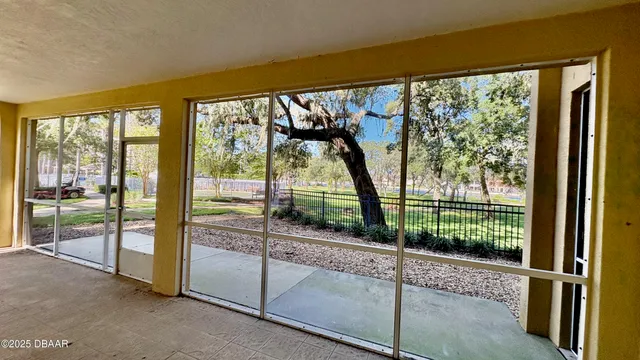 a view of a room with wooden floor and a porch