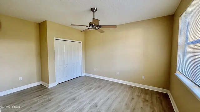 wooden floor in an empty room with a window