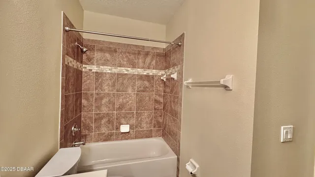 a bathroom with a shower and a bath tub