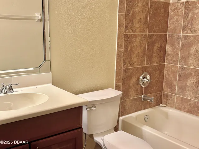 a bathroom with a sink and mirror with toilet
