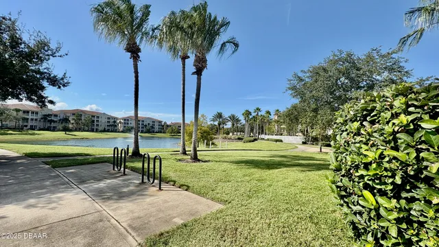 a view of a backyard with a patio table and chairs