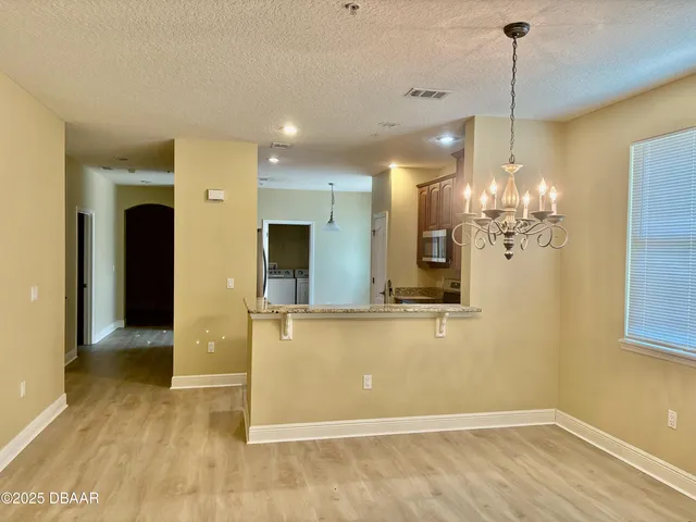 a view of a kitchen with a chandelier
