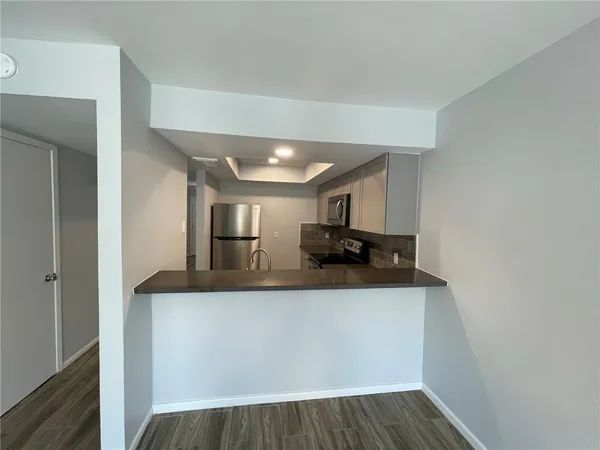 a view of living room with furniture and wooden floor