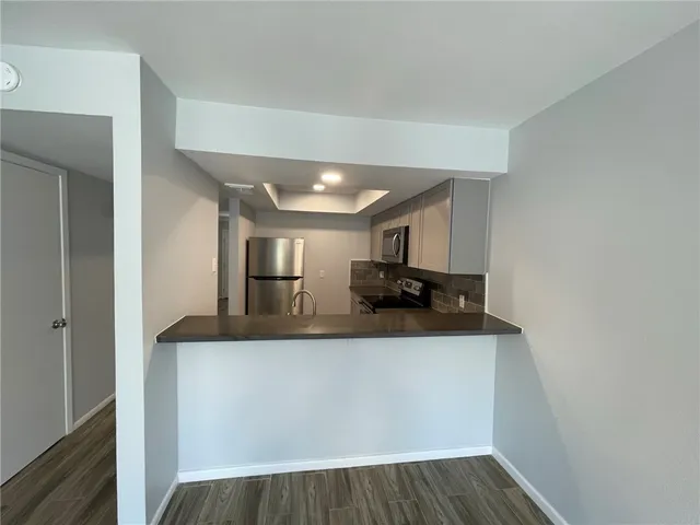 a view of living room with furniture and wooden floor