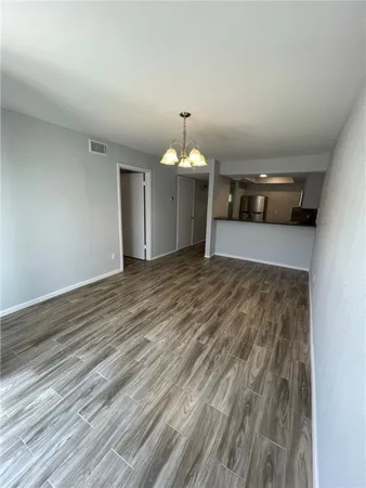 a view of a livingroom with wooden floor and a ceiling fan