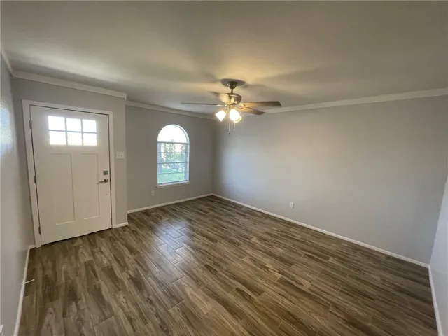 wooden floor in an empty room with a mirror