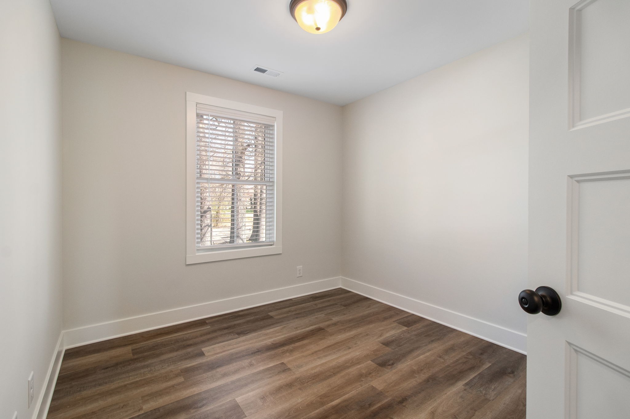 160 Excell Road, Unit D Clarksville, TN 37043 - Photo 26 of 34 a view of an empty room with wooden floor and window