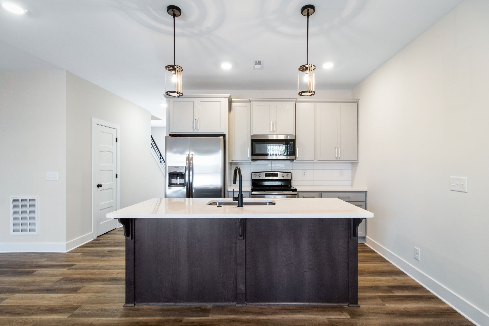 160 Excell Road, Unit D Clarksville, TN 37043 - Photo 8 of 34 a kitchen with kitchen island granite countertop a sink cabinets and wooden floor