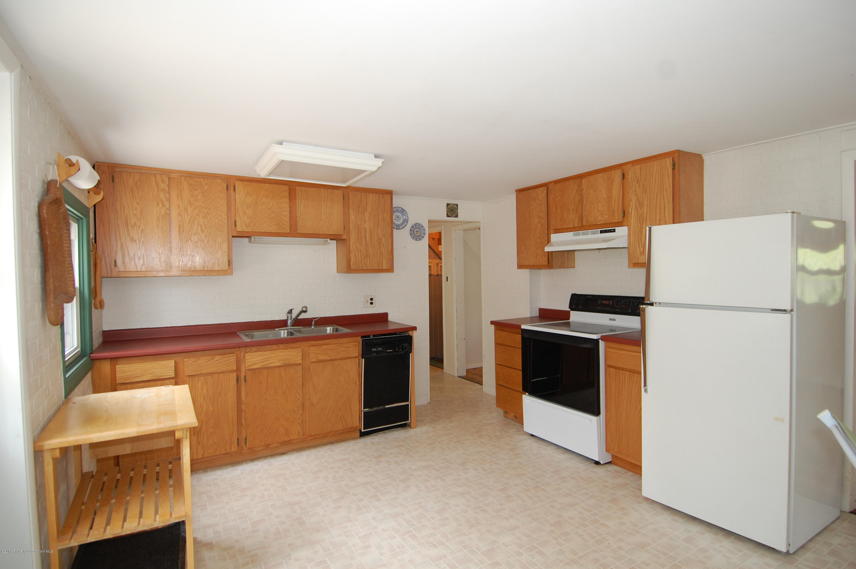1129 Corbin Road Kingsley, PA 18826 - Photo 19 of 24 a kitchen with stainless steel appliances a refrigerator a stove a sink and a refrigerator
