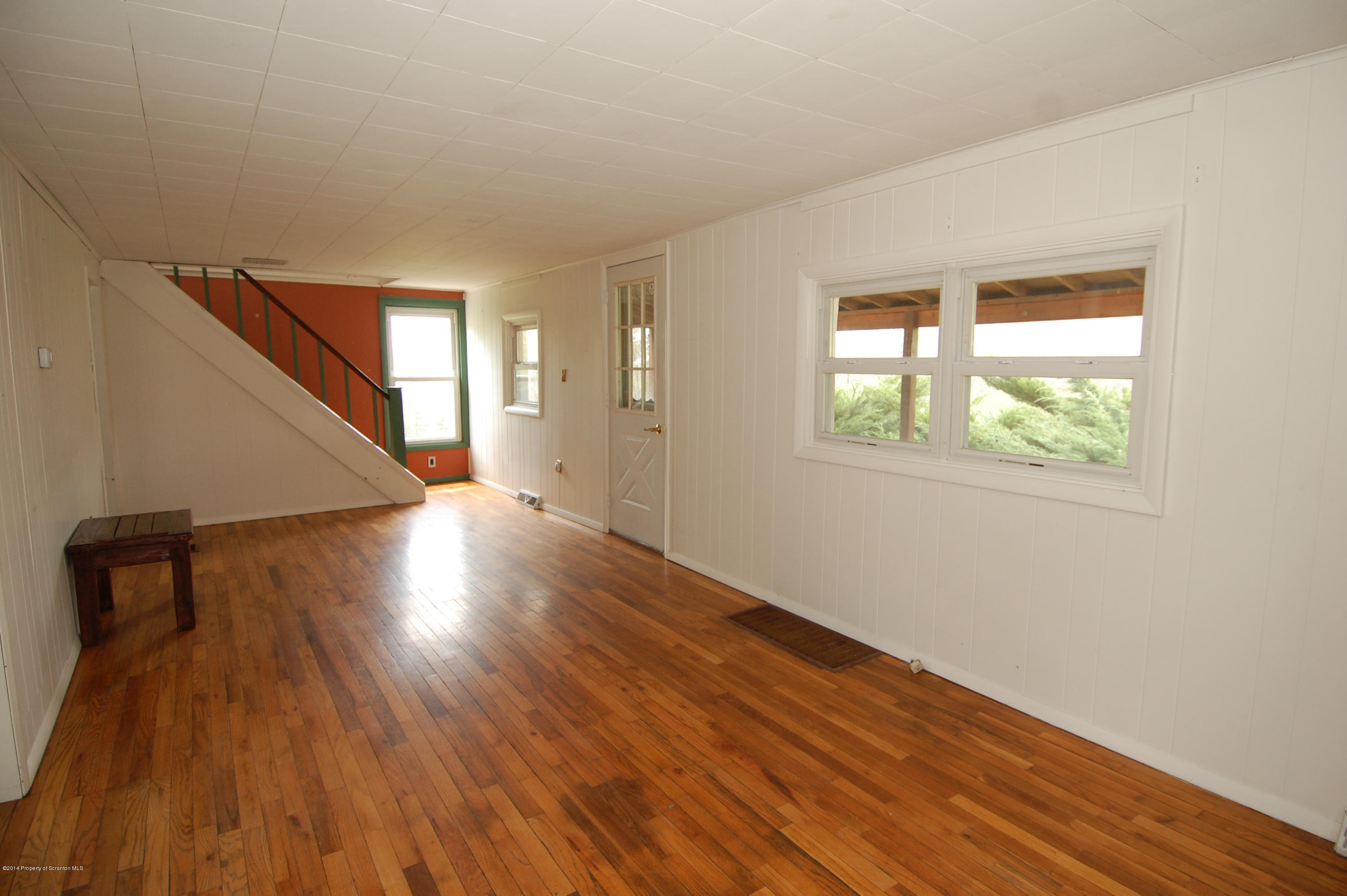 1129 Corbin Road Kingsley, PA 18826 - Photo 7 of 24 a view of an empty room with wooden floor and a window
