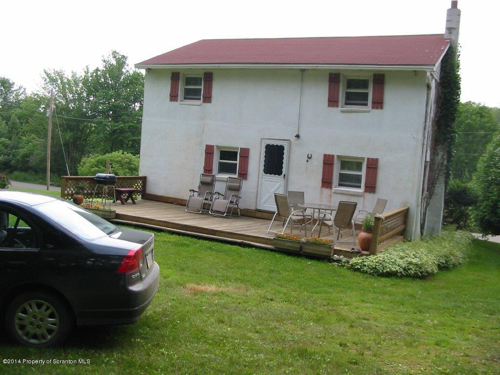 1129 Corbin Road Kingsley, PA 18826 - Photo 8 of 24 a front view of a house with a garden and swimming pool