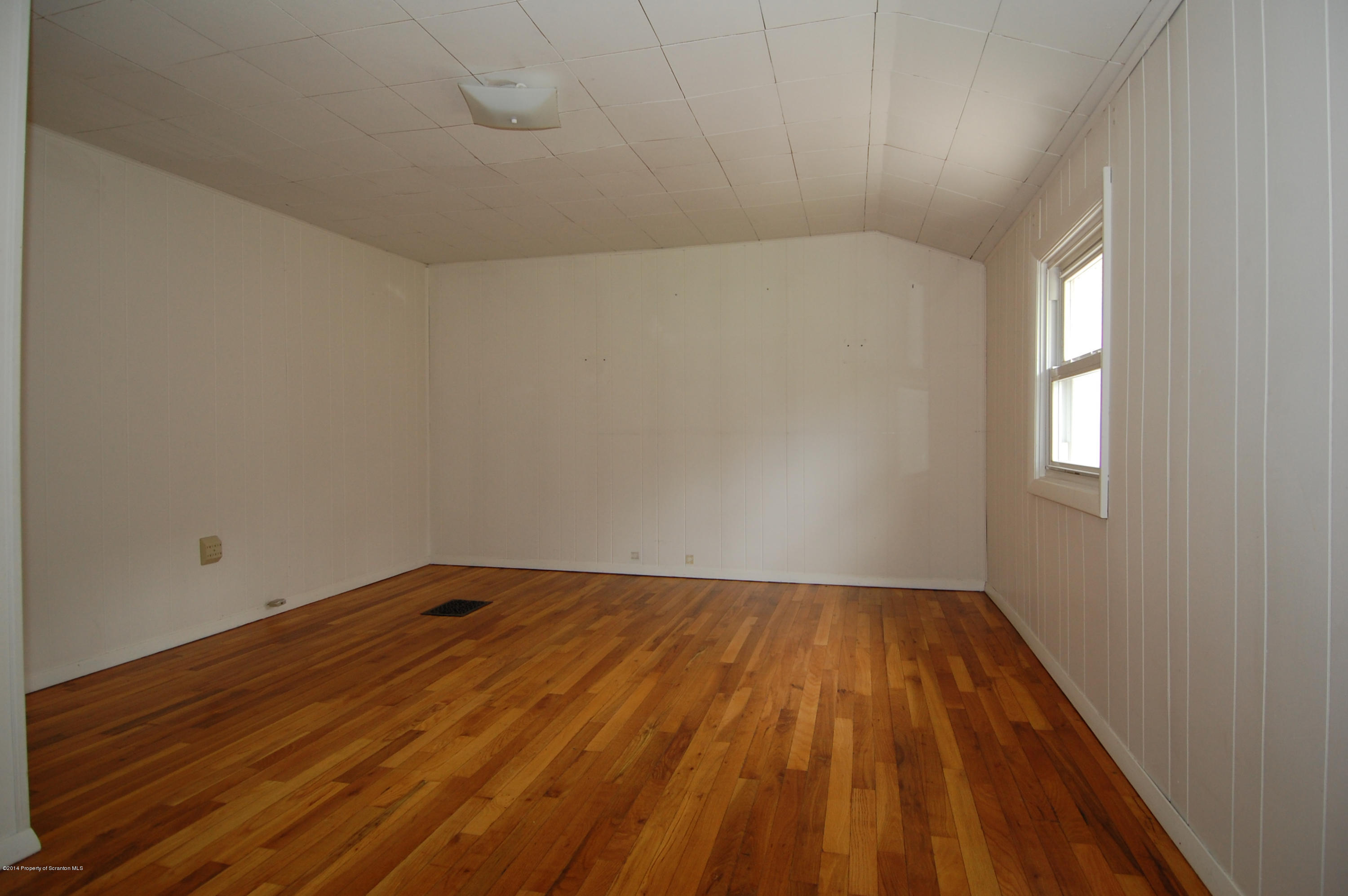 1129 Corbin Road Kingsley, PA 18826 - Photo 10 of 24 a view of room with window and hardwood floor