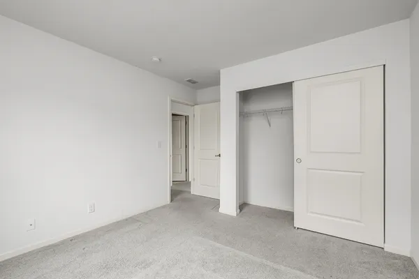 an empty room with closet area