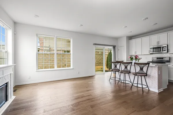 a view of a kitchen with dining table and chairs