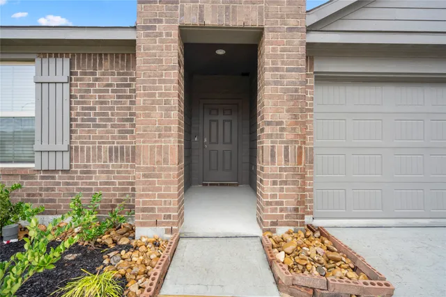 a view of front door of house with an outdoor space