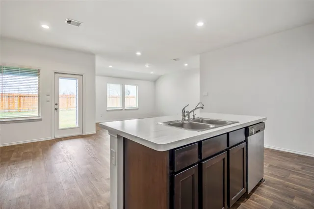 a bathroom with a sink a window and a mirror