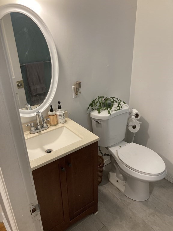 24 Baxter Street Worcester, MA 01602 - Photo 12 of 36 a bathroom with a toilet sink and mirror