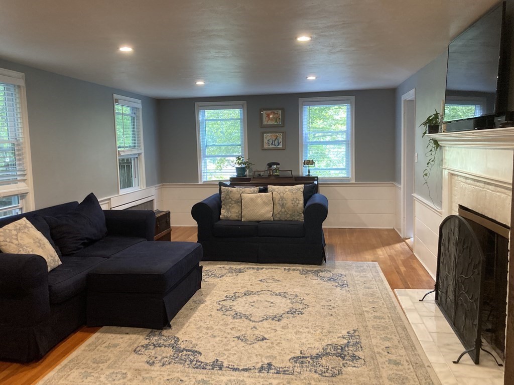 24 Baxter Street Worcester, MA 01602 - Photo 15 of 36 a living room with furniture a flat screen tv and a fireplace