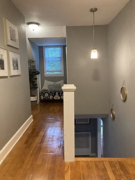 24 Baxter Street Worcester, MA 01602 - Photo 19 of 36 a bedroom with furniture and wooden floor