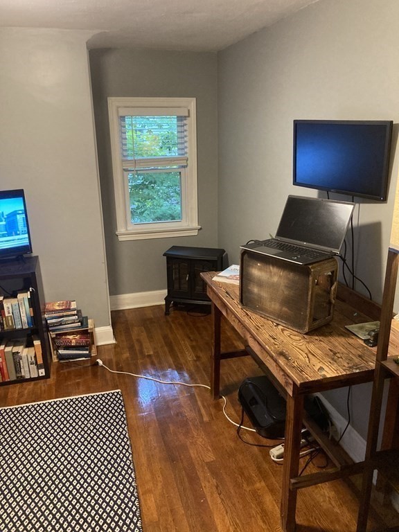 24 Baxter Street Worcester, MA 01602 - Photo 20 of 36 a living room with a couch and a window