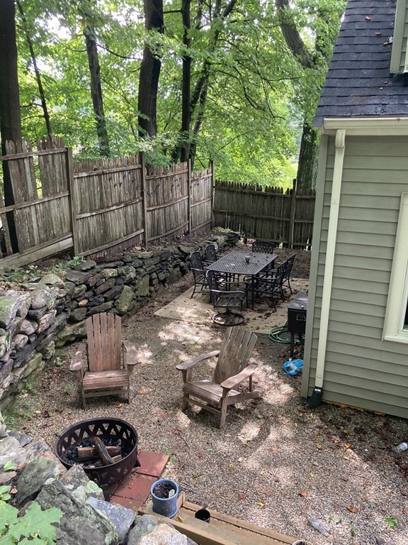 24 Baxter Street Worcester, MA 01602 - Photo 32 of 36 a view of backyard with table and chairs and wooden fence